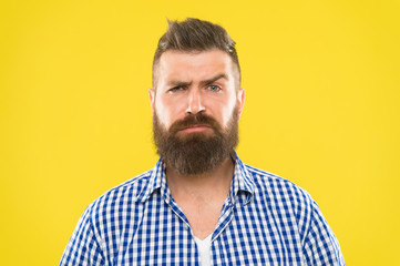Are you serious. Man serious face raising eyebrow not confident. Have some doubts. Hipster bearded face not sure in something. Doubtful bearded man on yellw background close up. Doubtful expression