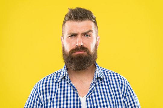 Are you serious. Man serious face raising eyebrow not confident. Have some doubts. Hipster bearded face not sure in something. Doubtful bearded man on yellw background close up. Doubtful expression