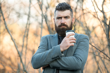 Drink it on the go. Man bearded hipster prefer coffee take away. Businessman drink coffee outdoors. Reloading energy. Relaxing coffee break. Hipster hold paper coffee cup and enjoy nature environment