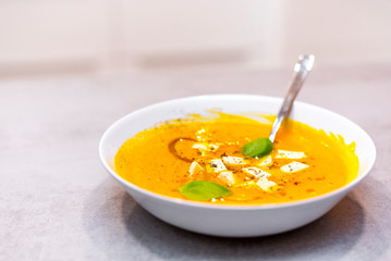 Pumpkin soup on the grey concrete table