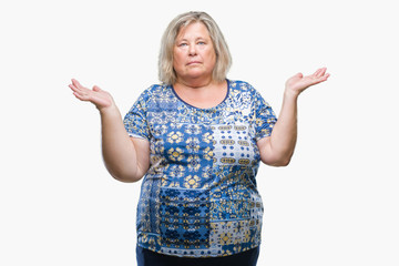 Senior plus size caucasian woman over isolated background clueless and confused expression with arms and hands raised. Doubt concept.