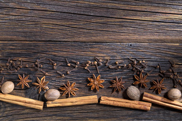 Christmas spices on a wooden background