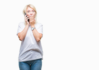 Young beautiful blonde woman calling and talking on smartphone over isolated background cover mouth with hand shocked with shame for mistake, expression of fear, scared in silence, secret concept