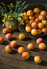 Apricots in a basket and flowers on the table