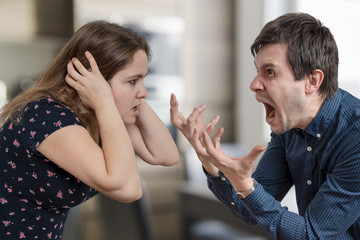Divorce concept. Young angry couple arguing and shouting.