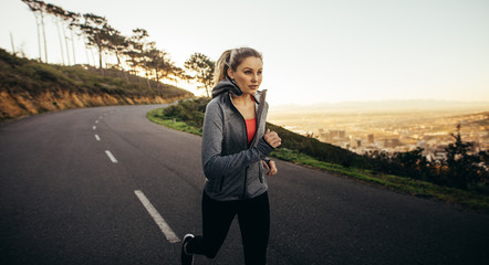 Female athlete running on road in the morning