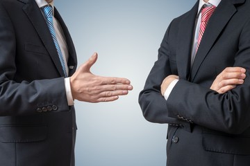 Handshake refuse. Man is refusing shake hand with businessman wh