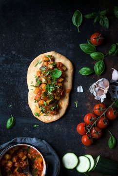 Vegan Coca Mallorquina (Mallorcan pizza) with tomatoes and zucchini