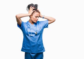 Young braided hair african american girl professional surgeon over isolated background suffering from headache desperate and stressed because pain and migraine. Hands on head.