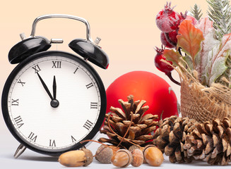 Composition of clock and christmas decorations on bright background