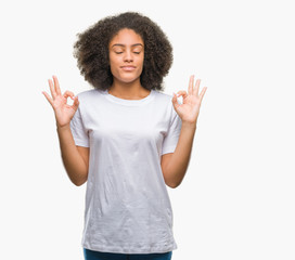 Young afro american woman over isolated background relax and smiling with eyes closed doing meditation gesture with fingers. Yoga concept.