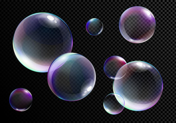 Vector illustration set of realistic bright soap bubbles with rainbow colors on transparent black background.