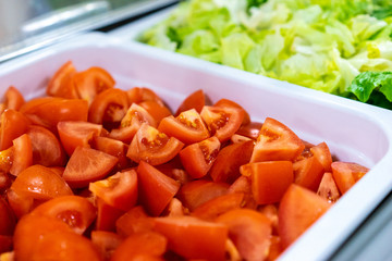 Vegetables in white containers. Tomatoes. Salad. A set of vegetables.