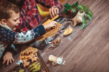 Father and son baking gingerbread Christmas cookies