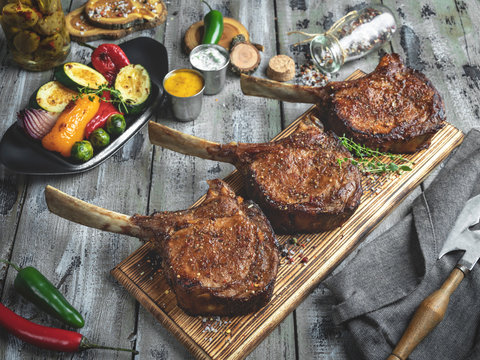 Grilled lamb,mutton meat chops with vegetables on a serving board. Rustic food concept