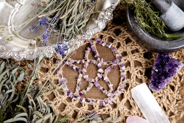 Amethyst Pentagram with dried herb bundles, mortar and pestle on crotchet jute altar cloth