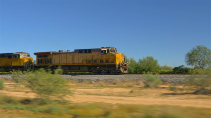 Obraz premium CLOSE UP: Long freight container train moving and transporting cargo