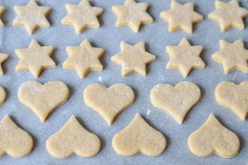 Christmas cookies background. Top view of raw Christmas cookies on baking sheet.	