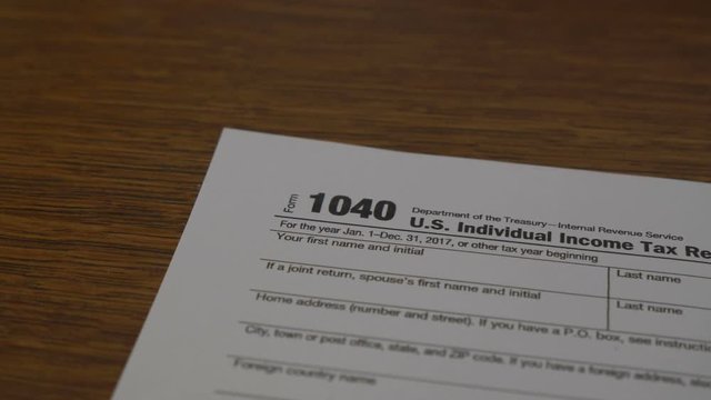 Dolly and close up of an IRS tax form