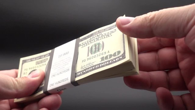 Leafing through a stack of banknotes