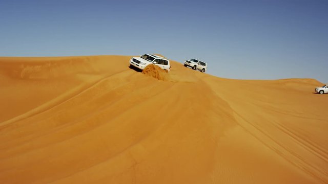 Aerial Drone of 4x4 Vehicles Driving Across Dubai Desert Sands
