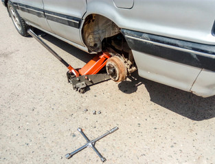 The car is at the tire shop. Under the jack the car in car-care center. The car with the removed...