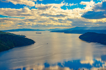 Fototapeta premium Scenic view of the ocean and shoreline at sunset in Maple Bay, Vancouver Island
