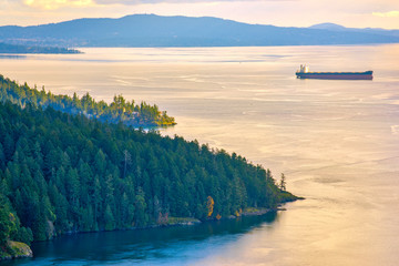 Scenic view of the ocean and shoreline at sunset in Maple Bay, Vancouver Island