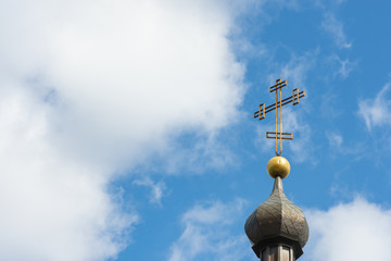 Fototapeta na wymiar Church cross close up against a blue sky. The concept of the Orthodox religion and Christianity