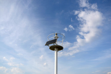 Solar powered lightouse. Dramatic sky in the background. 