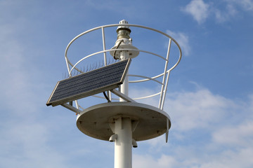 Solar powered lightouse. Dramatic sky in the background. 