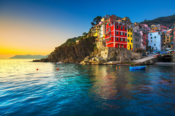 Fototapeta na wymiar Riomaggiore town, cape and sea landscape at sunset. Cinque Terre, Liguria, Italy