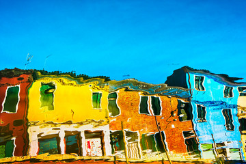 Burano colorful houses reflection in the water canal. Venice Italy