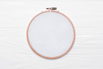 Tools for cross stitch. A hoop for embroidery and canvas on white