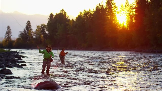 Male female rod and reel fly fishing in freshwater river 