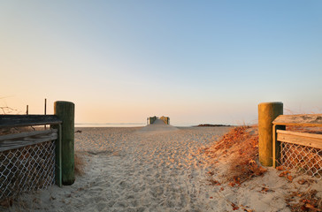 Overview of the entrance of Walnut Beach at sunrise Milford Connecticut, USA. Walnut Beach is a great place to spend the day strolling along the edge of the Long Island Sound or fishing from the pier. - obrazy, fototapety, plakaty
