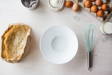 Ingredients for baking cake laid out on a white wooden table.selective focus.