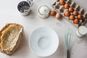 Ingredients for baking cake laid out on a white wooden table.selective focus.