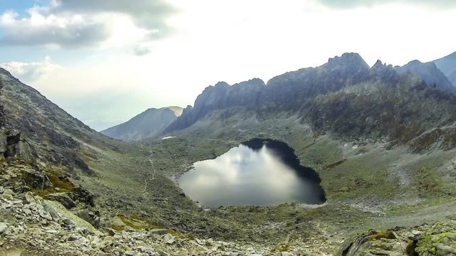 Hiking in High Tatras Mountains, Slovakia. Vysne Wahlenbergovo Pleso Lake (2154m). Mounts Ostra (2351m) on the background. Time Lapse