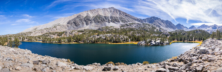 Panoramic view of alpine lake surrounded by the rocky ridges of the Eastern Sierra mountains; Box Lake, Little Lakes Valley trail, John Muir wilderness, California