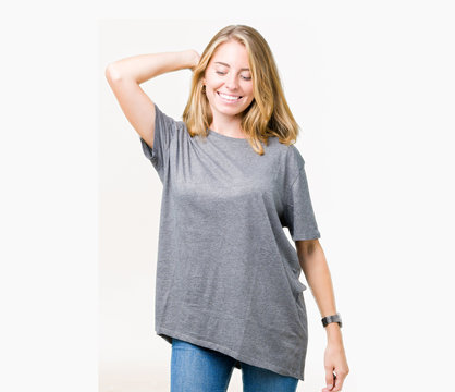 Beautiful young woman wearing oversize casual t-shirt over isolated background Dancing happy and cheerful, smiling moving casual and confident listening to music