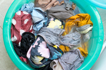 washing colorful clothes in the basin.