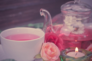 pot and cup of Rose tea on wood background