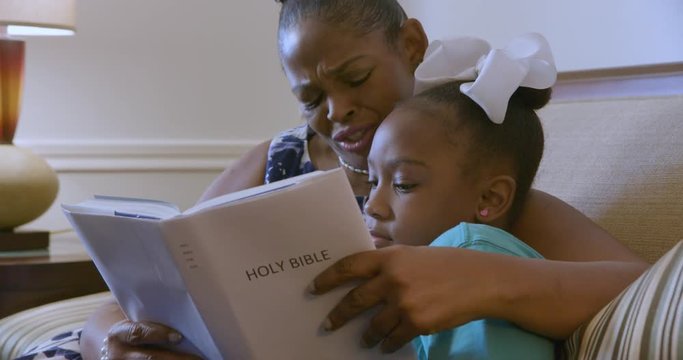  mom reads from the Bible to her daughter 