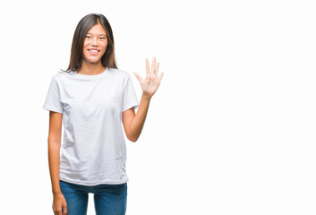 Obraz na płótnie Canvas Young asian woman over isolated background showing and pointing up with fingers number five while smiling confident and happy.