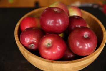 red apples in a wooden bowl
