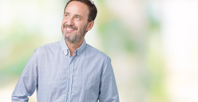 Handsome middle age elegant senior man over isolated background smiling looking side and staring away thinking.