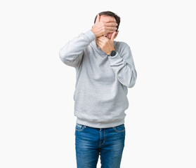 Fototapeta premium Handsome middle age senior man wearing a sweatshirt over isolated background Covering eyes and mouth with hands, surprised and shocked. Hiding emotion