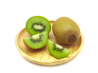 Slice of fresh juicy delicious and healthy kiwi fruit on wooden plate, isolated on white background.