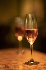 Glasses of champagne on background